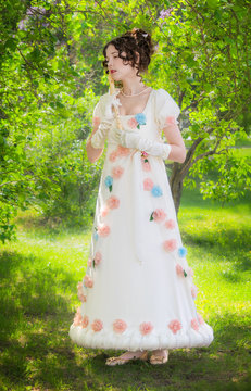 girl musician with a flute in the garden.