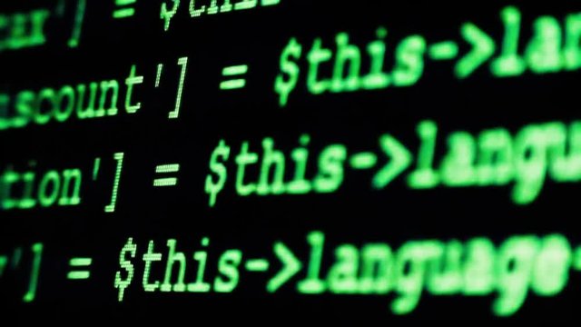 The Process Of Writing A Computer Program On A Computer Monitor. Text Is Entered