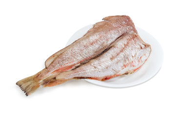 Two carcasses of uncooked red cod on white dish