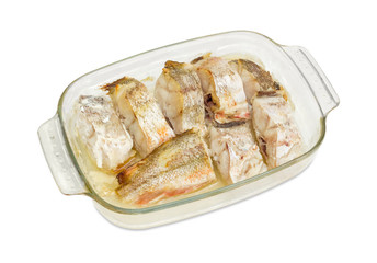 Baked pieces of the red cod in glass casserole pan