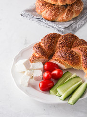 Turkish breakfast with simit, cheese, cherry tomato, cucumber.