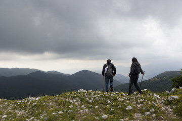 Fototapeta premium man and woman hikers on mountain