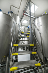 Staircase lift between two metal cisterns.