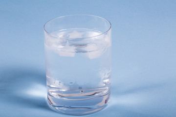 Glass with Water on Green Background