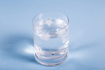 Glass with Water on Green Background