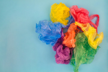   Different plastic bags on blue background. Top view. 