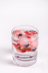 Ice berries in glass of water