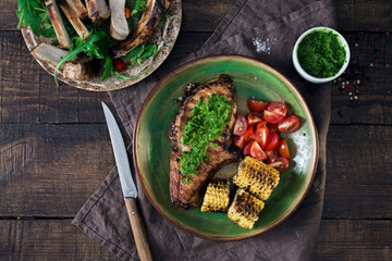 Beef steak with fried corn and salad