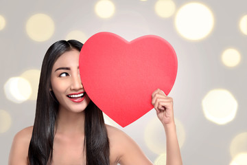 Happy asian woman with red heart in hand