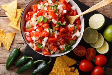 Mexican pico de gallo from tomatoes, onions, cilantro and jalapeno pepper close-up. horizontal top...