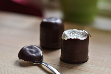 chocolate marsh-mallow whit silver spoon on light wooden background