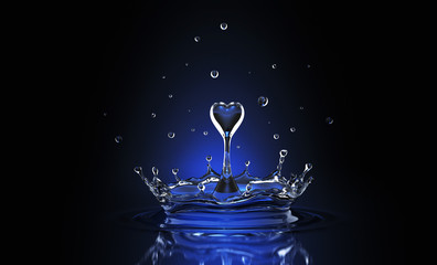 Water drop in form of heart in blue spot light