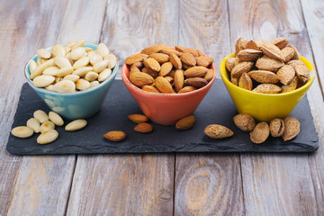 Assortment of almond nuts - peeled and fried, unpeeled and almonds in shells