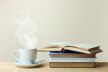 A stack of books and a cup of tea