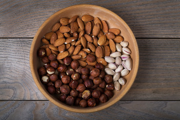 Pistachio, hazelnut, almonds in wooden plate