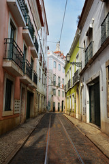 Fototapeta na wymiar Colorful street in Alfama quarter, old picturesque part of Lisbon, Capital of Portugal