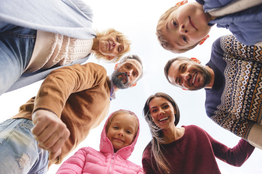 Bottom view of a big positive family standing outdoors