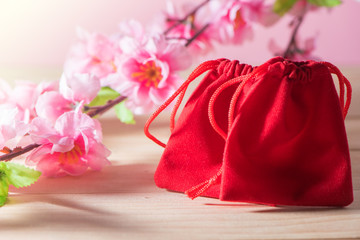 Red Gift Bag on Old Shabby Wooden Table concept Christmas and Newyear.