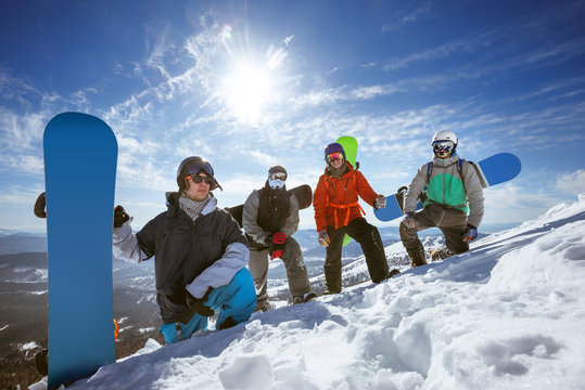Four snowboarders at ski slope