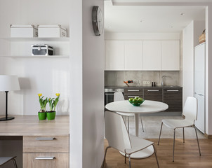 Interior of modern apartment in scandinavian style with kitchen and workplace.