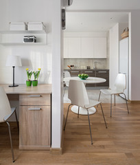 Interior of modern apartment in scandinavian style with kitchen and workplace.