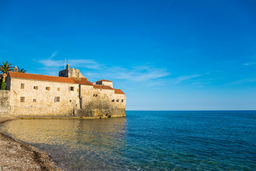 The fortress of the old city in the rays of sunset. Budva, Montenegro.