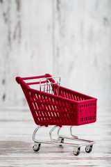 Miniature Pink Toy Shopping Cart on White Background