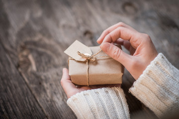 Female hands opening gift box  as holiday background