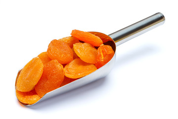 scoop full of dried apricots isolated on white background. clipping path