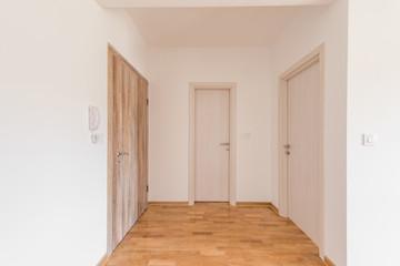 Empty coridor with wooden front doors