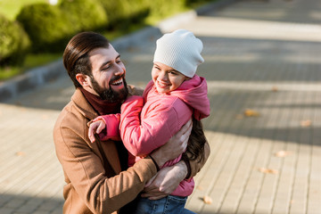 Fototapeta premium happy father with daughter hugging. outside