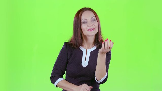Lady sends kisses to others. Green screen