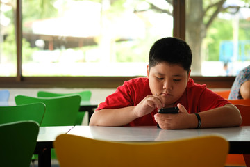 Asian child Boy are addictive playing tablet and mobile phones, Game Addiction