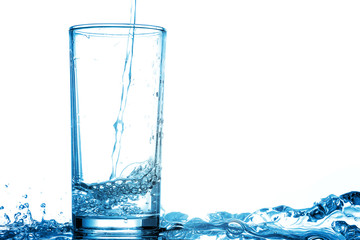 Pour drinking water into the glass with copy space.