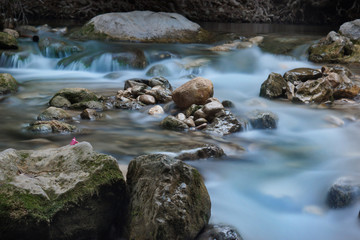 The river flows through the rocks