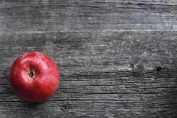 basket with red apples on wooden background