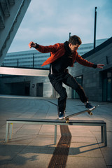young skateboarder performing trick on bench