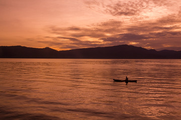 Sunrise Sunrise with reflections at Lake Toba, Samosir Island, Indonesia.