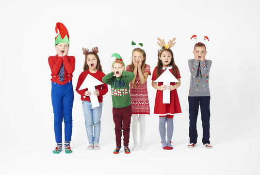 Surprised group of children in christmas costume