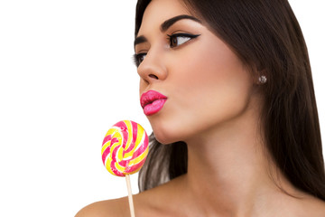 Close up of beautiful sexy woman model with pink lips and lollipop on white isolate background, profile. brunette girl with professional makeup
