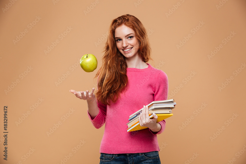 Sticker portrait of a friendly pretty redhead girl holding apple