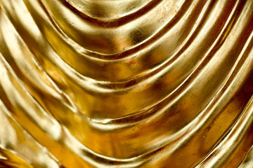 Abstract gold background, glossy metal that is a luxurious fabric is wave