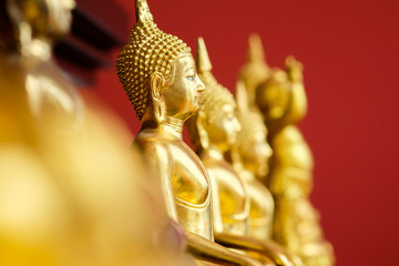 Golden Buddha On a red background with selective focus