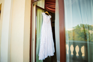 Wedding dress weighs in on the door.