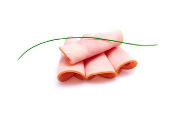 Cooked boiled ham sausage or rolled bologna slices isolated on white background with herbs and spices