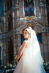 Fototapeta premium Stylish elegant bride on background the old church
