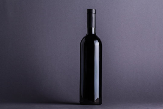 Red wine bottle on grey