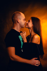 Girl and boy on the background of a sunset color