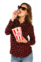 Woman in 3d stereo glasses holding bucket with popcorn