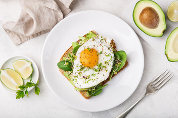 toast with avocado, spinach and fried egg - obrazy, fototapety, plakaty